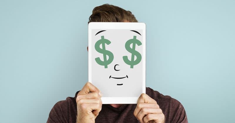 employee holding up dollar signs