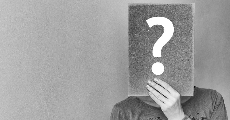 hr holding up book with question mark