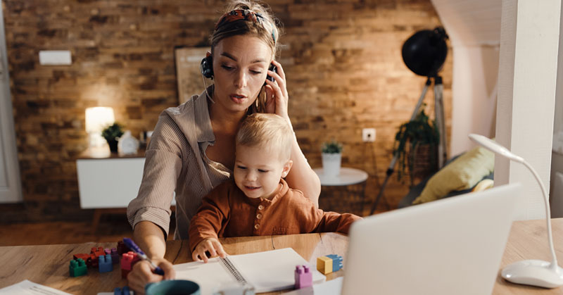 work at home mom with child on lap